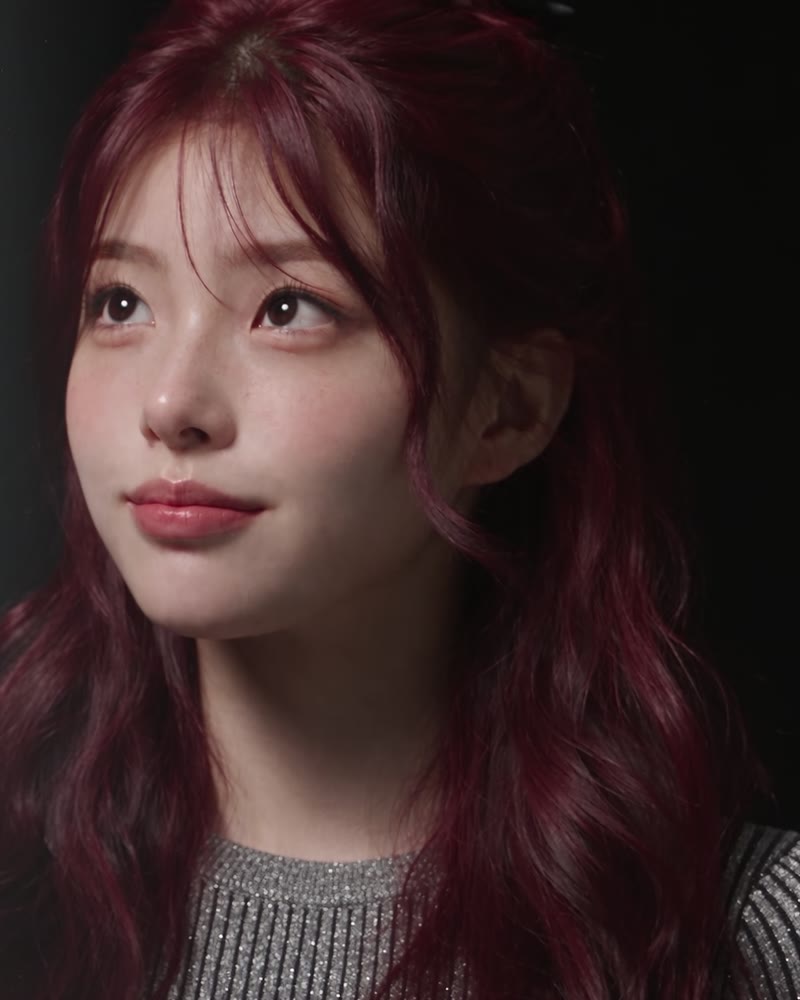 Seori looking up, burgundy hair, dark studio